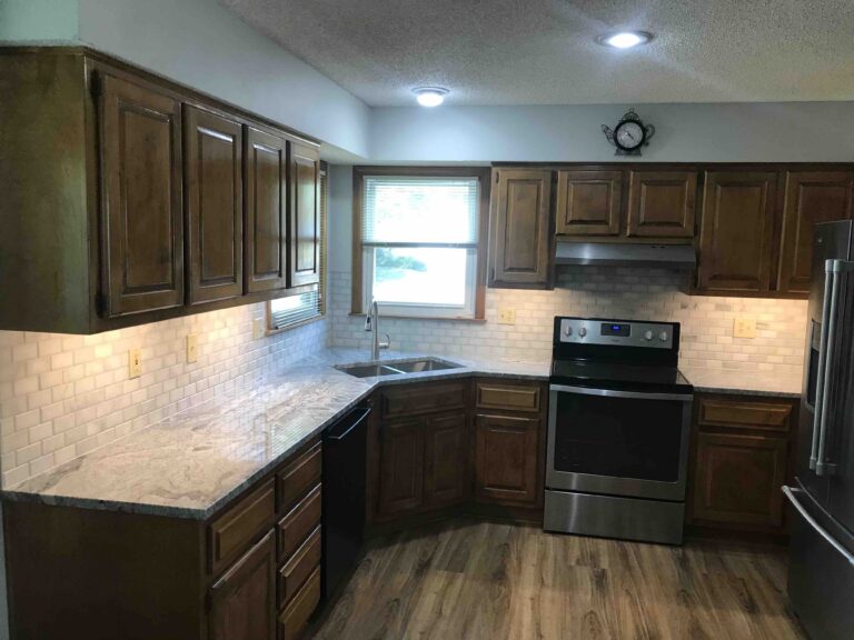 Kitchen renovated with new countertops and backsplash.