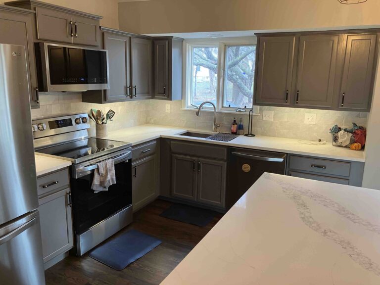 Remodeled, modern kitchen with new cabinets, neutral colors, granite countertops, stainless steel appliances.