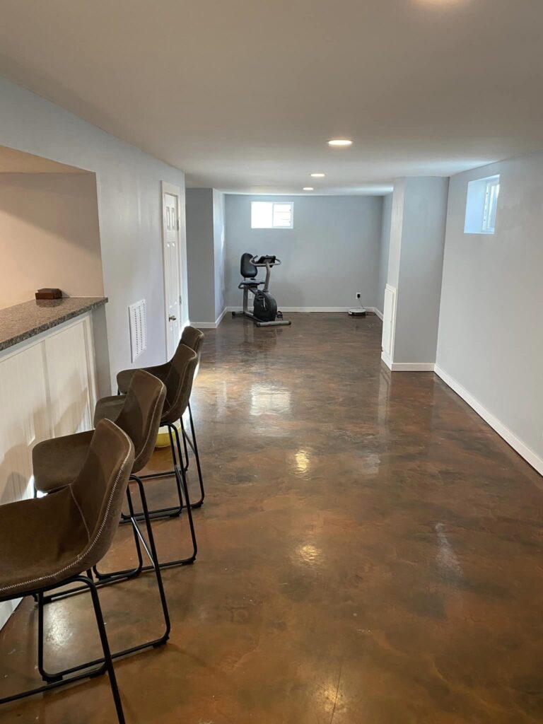 Full basement remodel including the movement of a wall, movement of plumbing, new insulation, drywall and trim. They also refinished their bar with wainscoting and new granite countertops.