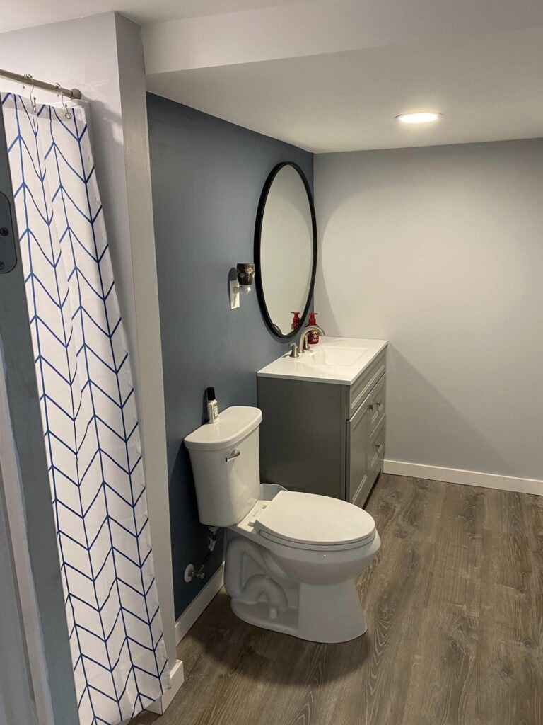 Basement bathroom refinished. Toilet and shower re-plumbed, shower pan and surround installed, new flooring and sheetrock, new vanity.