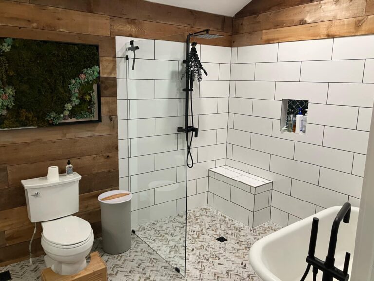 From fully-gutted to rustic yet modern. This bathroom was previously just studs and how has a zero-entry shower, a free standing tub, new vanity, and tile throughout.